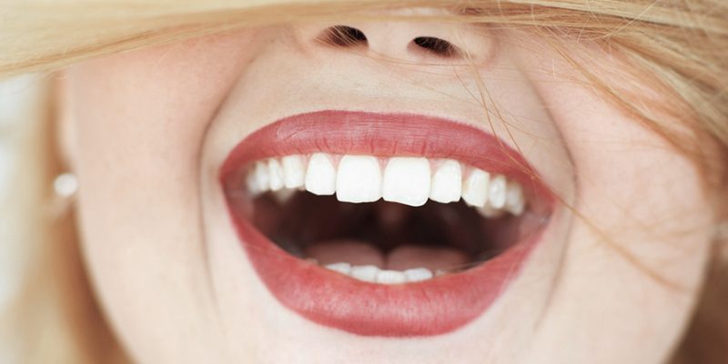 Happy laughing woman with red hair close-up. portrait of unrecognizable carroty girl with wide perfect smile. Fun, gladness, joy concept