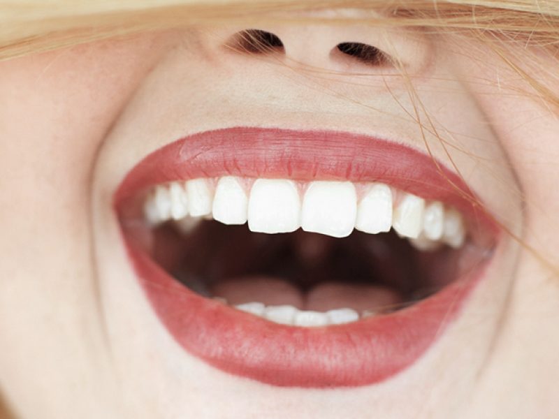 Happy laughing woman with red hair close-up. portrait of unrecognizable carroty girl with wide perfect smile. Fun, gladness, joy concept