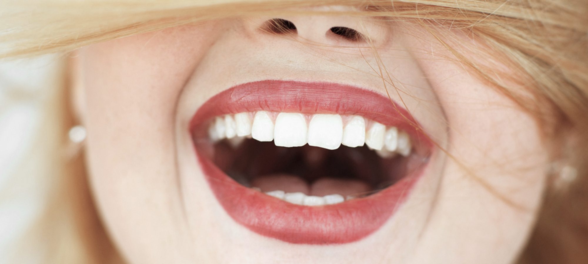 Happy laughing woman with red hair close-up. portrait of unrecognizable carroty girl with wide perfect smile. Fun, gladness, joy concept