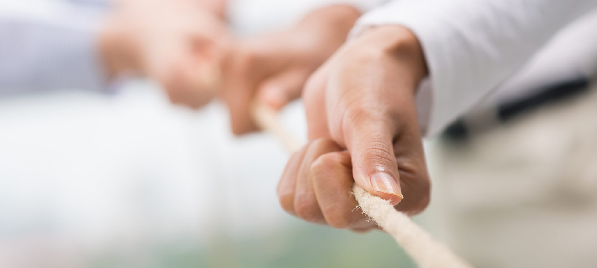 Concept image of business team using a rope as an element of the teamwork on the foreground